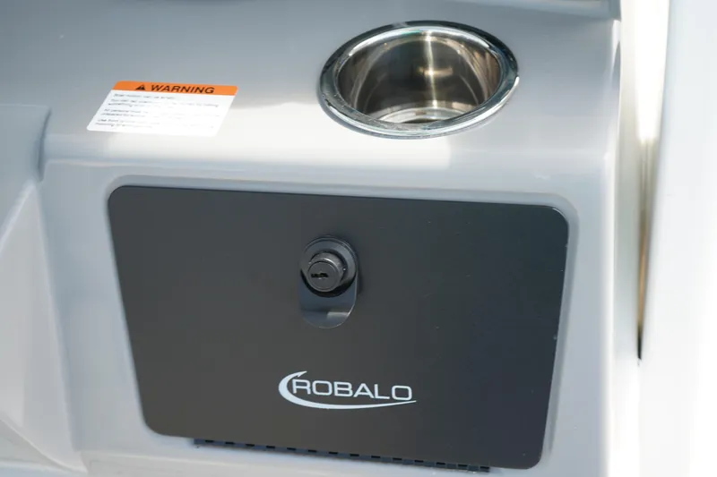 Slide: The Image of 2026 Robalo R250 Center Console boat detail with cup holder and storage compartment. - 26