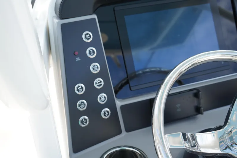 Slide: The Image of Steering console of 2026 Robalo R250 Center Console boat with control panel and display. - 30