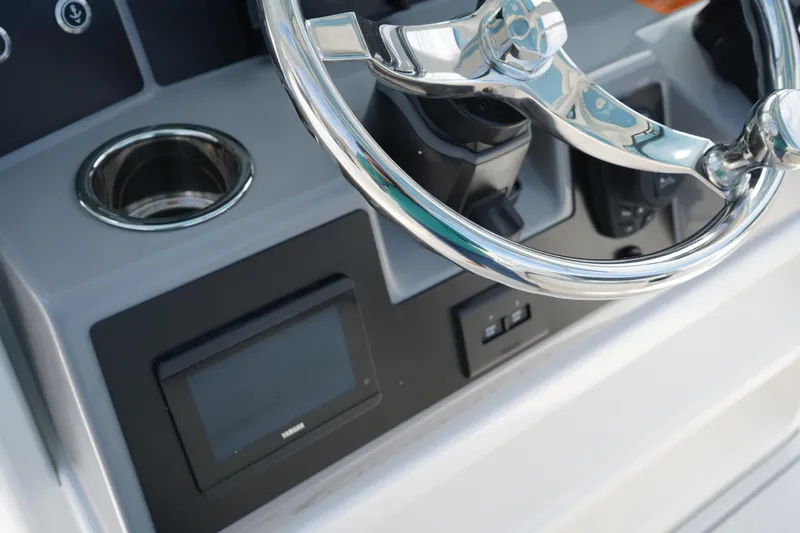 Slide: The Image of 2026 Robalo R250 Center Console steering wheel and dashboard close-up. - 31