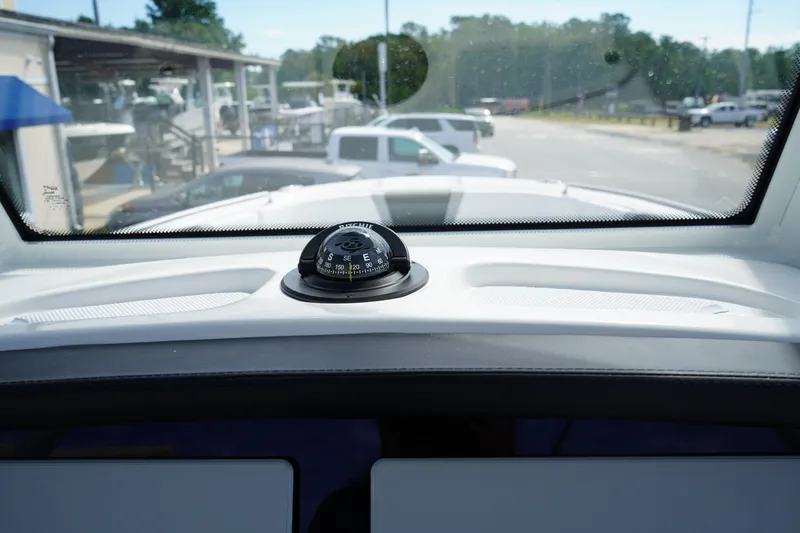 Slide: The Image of Compass on 2026 Robalo R250 Center Console dashboard, view through windshield. - 32