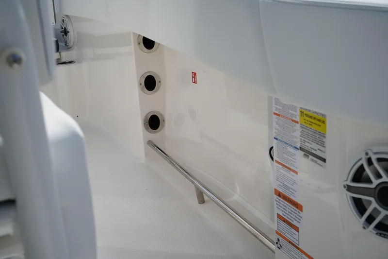 Slide: The Image of 2026 Robalo R250 Center Console interior with safety labels and speaker detail. - 33