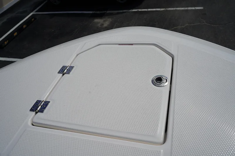Slide: The Image of 2026 Robalo R250 Center Console boat deck with storage hatch. - 48
