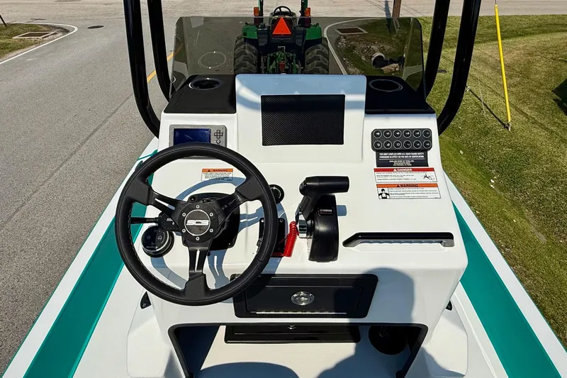 Slide: The Image of 2026 SCB R24 boat console with steering wheel, controls, and dashboard on a sunny day. - 10