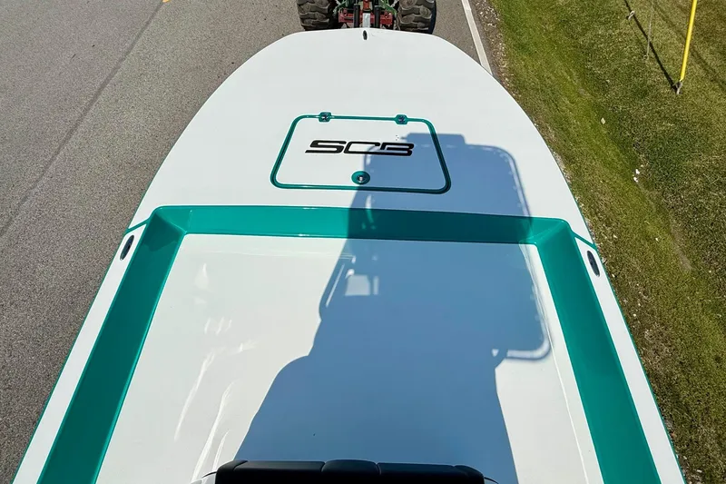 Slide: The Image of 2026 SCB R24 boat on road, top view with shadow and logo. - 13