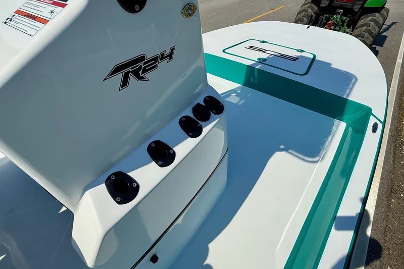 Slide: The Image of 2026 SCB R24 boat with sleek design and teal accents on deck. - 14
