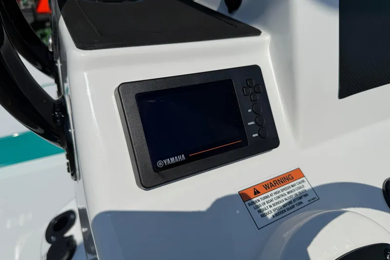 Slide: The Image of Control panel of 2026 SCB R24 boat featuring Yamaha display and warning label. - 16