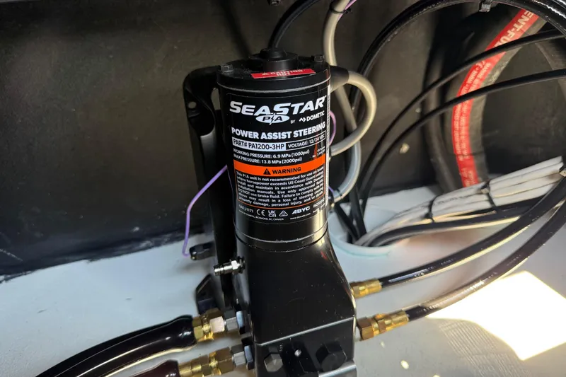 Slide: The Image of SeaStar power assist steering unit in SCB R24, 2026 model, with hydraulic connections. - 18