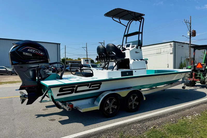 Slide: The Image of 2026 SCB R24 boat with Yamaha engine on trailer, parked outdoors. - 4