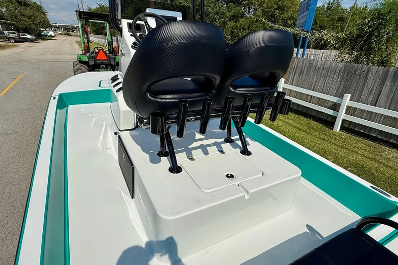 Slide: The Image of 2026 SCB R24 boat with dual black seats and rod holders on a sunny day. - 8