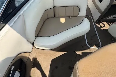 Slide: The Image of 2005 Malibu Sunsetter 23 XTi boat interior with beige and white seating. - 10