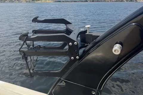 Slide: The Image of 2005 Malibu Sunsetter 23 XTi boat with wakeboard rack on a calm lake. - 13