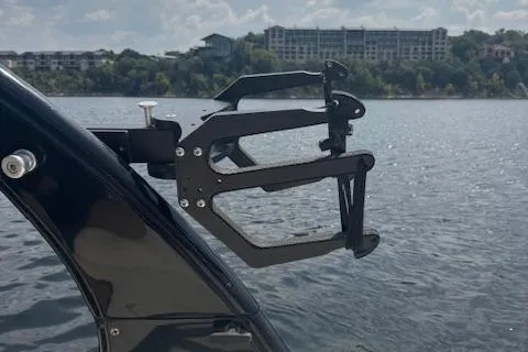 Slide: The Image of 2005 Malibu Sunsetter 23 XTi boat with wakeboard rack on a lake. - 14