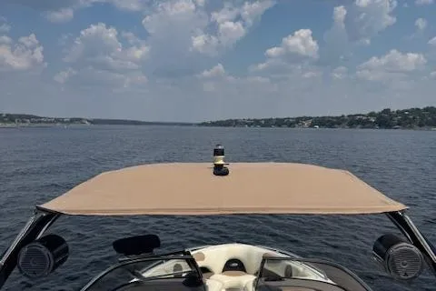 Slide: The Image of 2005 Malibu Sunsetter 23 XTi boat on a lake under a cloudy sky. - 15