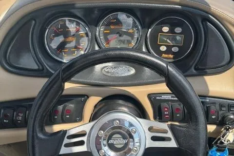 Slide: The Image of Dashboard of 2005 Malibu Sunsetter 23 XTi boat with steering wheel and gauges. - 6