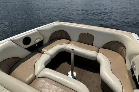 Slide: The Image of 2005 Malibu Sunsetter 23 XTi boat interior with beige seating on calm water. - 8