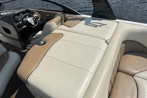 Slide: The Image of 2005 Malibu Sunsetter 23 XTi boat interior with beige seating and steering wheel. - 9