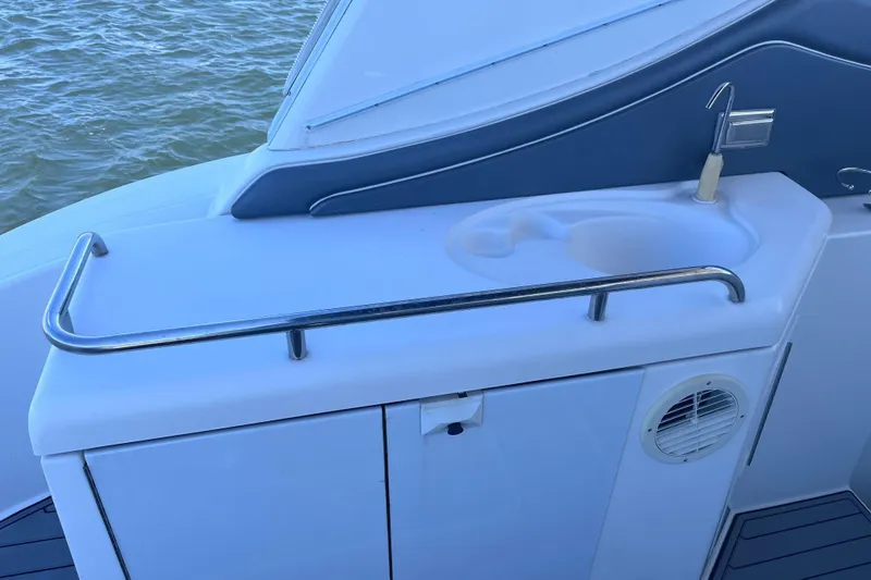 Slide: The Image of 2007 Cruisers Yachts 370 Express boat sink area with railing and water view. - 11