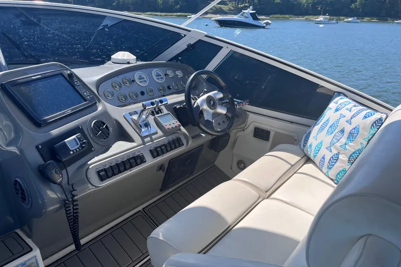Slide: The Image of 2007 Cruisers Yachts 370 Express helm with modern controls and comfortable seating. - 13