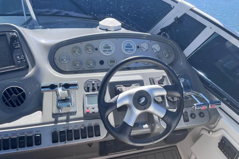 Slide: The Image of 2007 Cruisers Yachts 370 Express helm with steering wheel and control panel. - 14