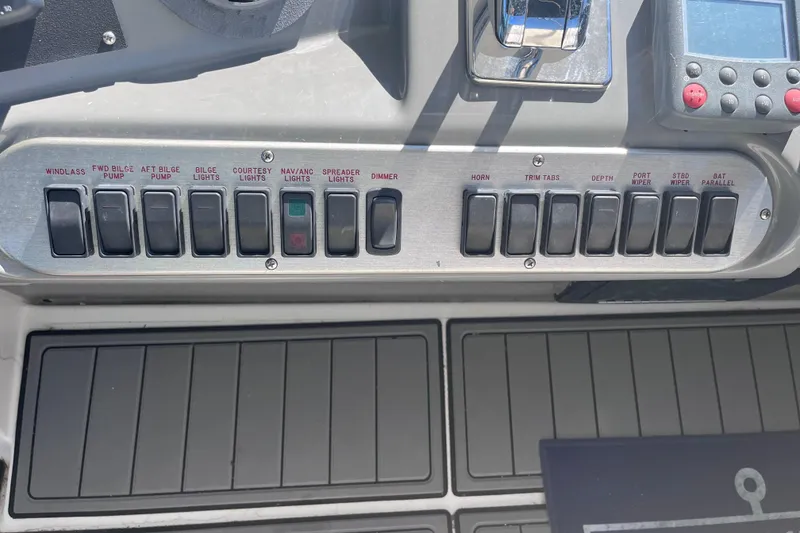 Slide: The Image of Control panel of a 2007 Cruisers Yachts 370 Express with labeled switches and buttons. - 16