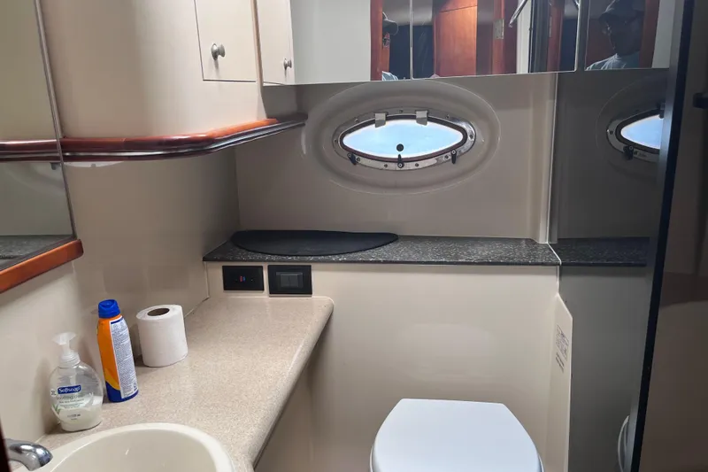 Slide: The Image of Bathroom interior of 2007 Cruisers Yachts 370 Express with porthole and countertop. - 24