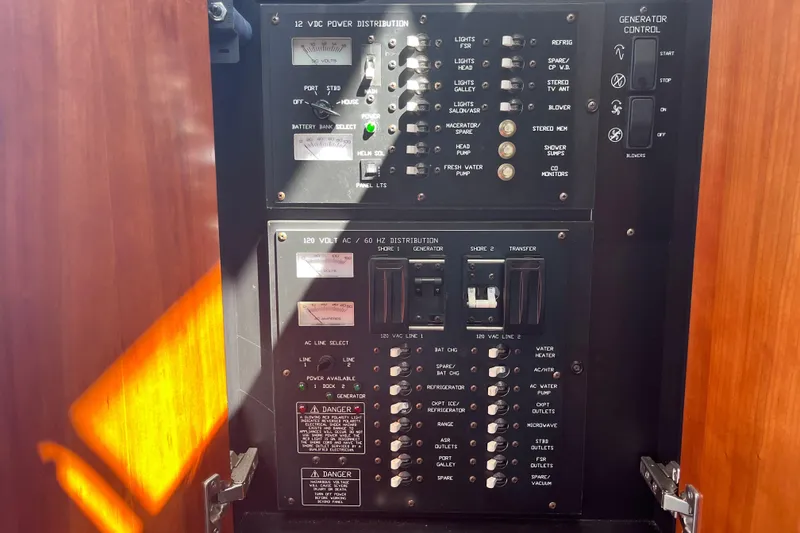 Slide: The Image of Electrical control panel on a 2007 Cruisers Yachts 370 Express, featuring power distribution and generator controls. - 33