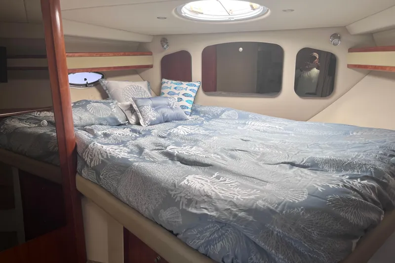 Slide: The Image of Luxurious cabin interior of 2007 Cruisers Yachts 370 Express with elegant bedding. - 19