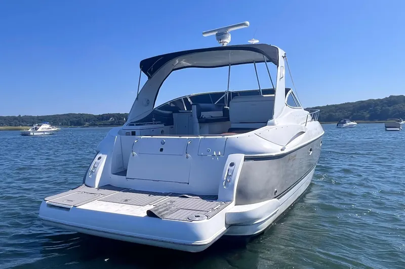 Slide: The Image of 2007 Cruisers Yachts 370 Express on calm water, rear view, sunny day. - 2