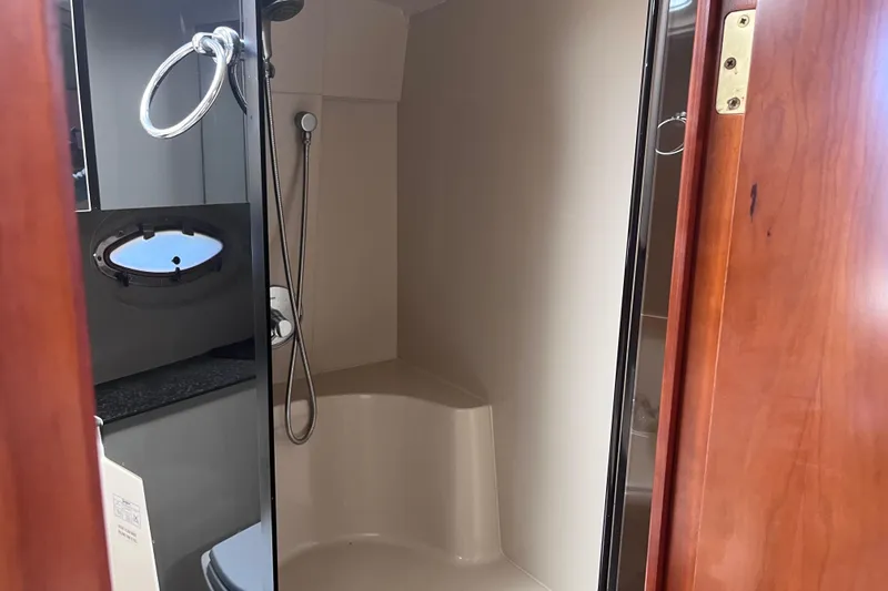 Slide: The Image of Bathroom interior of 2007 Cruisers Yachts 370 Express with shower and porthole window. - 25