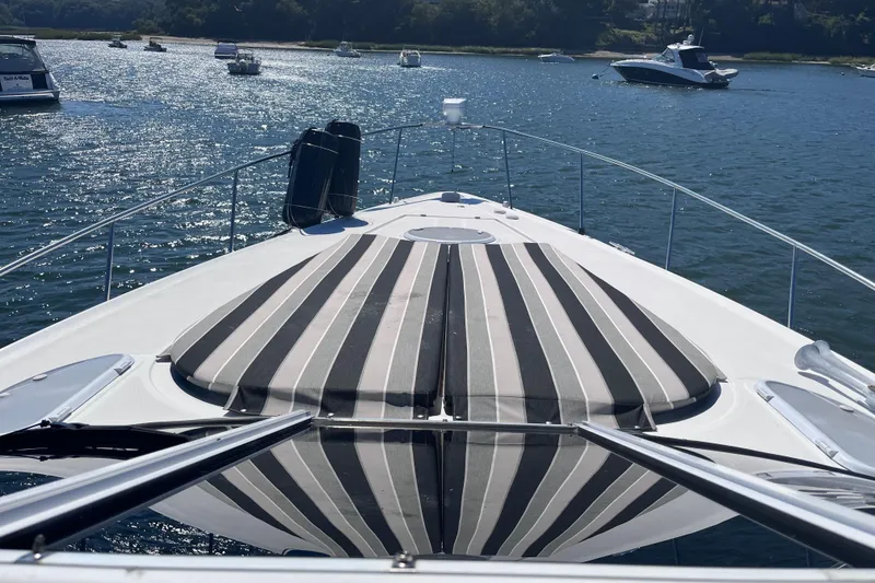 Slide: The Image of 2007 Cruisers Yachts 370 Express on water, featuring striped deck cushions. - 26