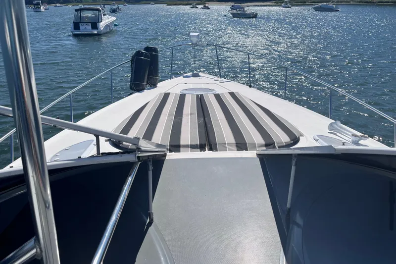 Slide: The Image of 2007 Cruisers Yachts 370 Express on water, featuring striped deck cushions. - 27