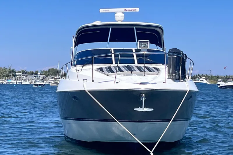 Slide: The Image of 2007 Cruisers Yachts 370 Express on water, front view, clear blue sky. - 6