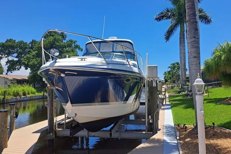 The Image of 2008 Formula 34 Performance Cruiser docked by a canal under a clear blue sky. - 0