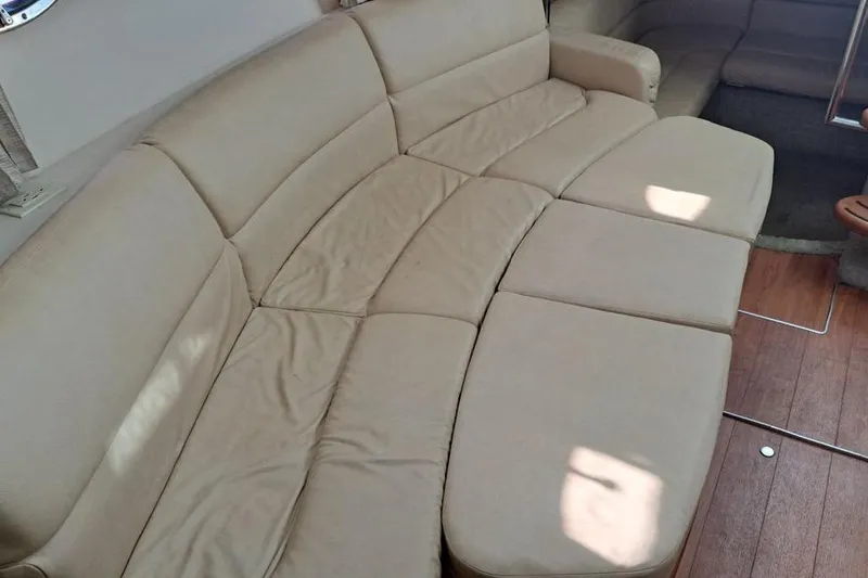 Slide: The Image of 2008 Formula 34 Performance Cruiser interior with beige seating and wooden table. - 10
