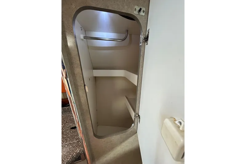 Slide: The Image of 2008 Formula 34 Performance Cruiser interior with open closet and tropical-patterned bedding. - 14