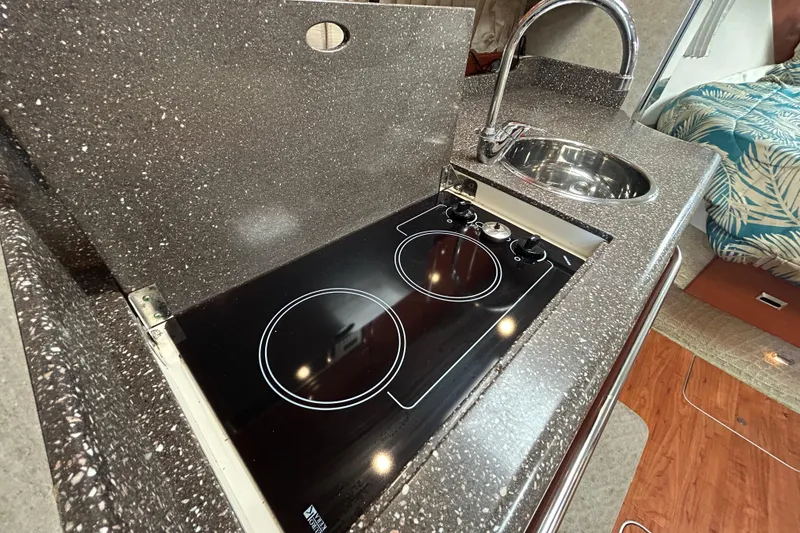 Slide: The Image of 2008 Formula 34 Performance Cruiser kitchen with sink, stove, and microwave. - 17