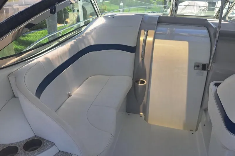 Slide: The Image of 2008 Formula 34 Performance Cruiser interior with white and blue seating, cup holders, and table. - 35