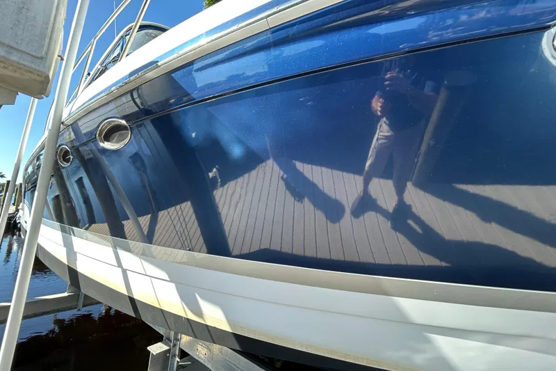 Slide: The Image of 2008 Formula 34 Performance Cruiser docked by a sunny waterfront with palm trees. - 44