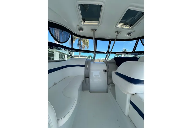 Slide: The Image of 2008 Formula 34 Performance Cruiser interior with seating and helm, under clear blue sky. - 53