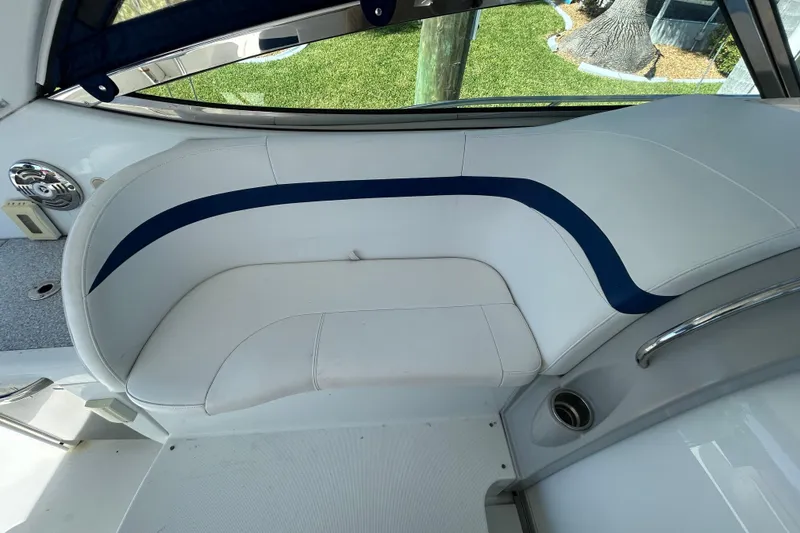 Slide: The Image of 2008 Formula 34 Performance Cruiser interior with white seating, docked near waterfront homes. - 57