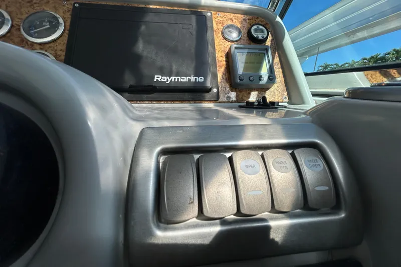 Slide: The Image of Control panel of a 2008 Formula 34 Performance Cruiser with labeled switches and buttons. - 65