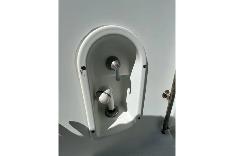 Slide: The Image of 2008 Formula 34 Performance Cruiser interior with seating and table, docked with Florida flag. - 75