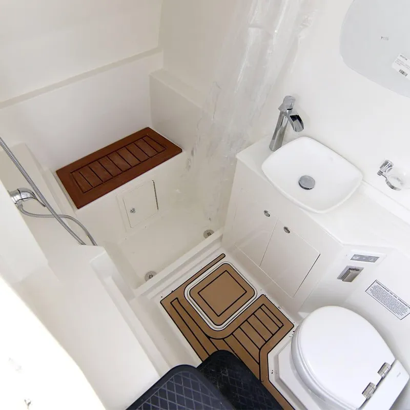 Slide: The Image of 2026 World Cat 400DC-X Island boat bathroom with modern fixtures and wooden accents. - 10