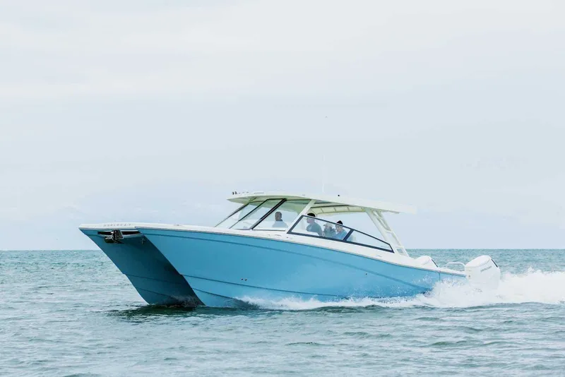 Slide: The Image of 2026 World Cat 400DC-X Island cruising on open water, showcasing sleek design and performance. - 2
