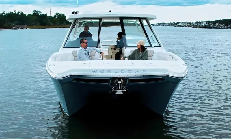 Slide: The Image of 2026 World Cat 400DC-X Island boat on water with passengers enjoying a scenic ride. - 3