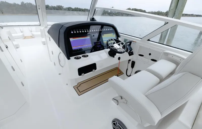 Slide: The Image of 2026 World Cat 400DC-X Island boat interior with modern dashboard and steering wheel. - 5