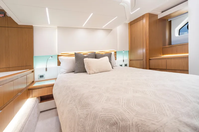 Slide: The Image of Luxurious 2025 Tiara Yachts EX 54 bedroom with modern wood accents and ambient lighting. - 37
