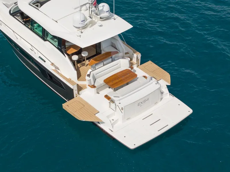 Slide: The Image of 2025 Tiara Yachts EX 54 luxury yacht on blue ocean water. - 4