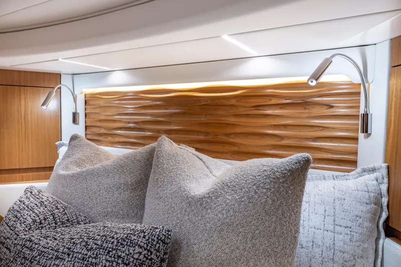 Slide: The Image of Luxurious 2025 Tiara Yachts EX 54 cabin with elegant wood paneling and plush pillows. - 44