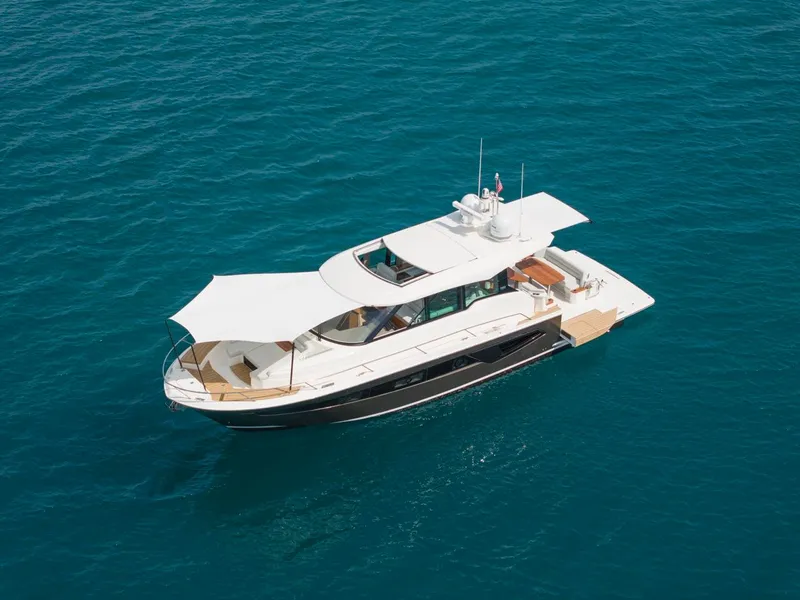 Slide: The Image of 2025 Tiara Yachts EX 54 cruising on clear blue water. - 5
